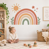 Child playing with wooden toys beneath a terracotta rainbow and leaf wall sticker.