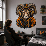 Person seated at a gaming desk beside a ram gamer wall decal in a bedroom.
