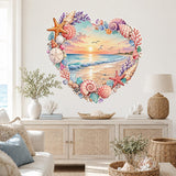 Heart-shaped beach sunset framed by seashells and starfish wall decal above a white coastal sideboard.