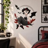 Gothic girl with bat wings wall decal above a dark metal bed and a wooden desk in a bedroom.