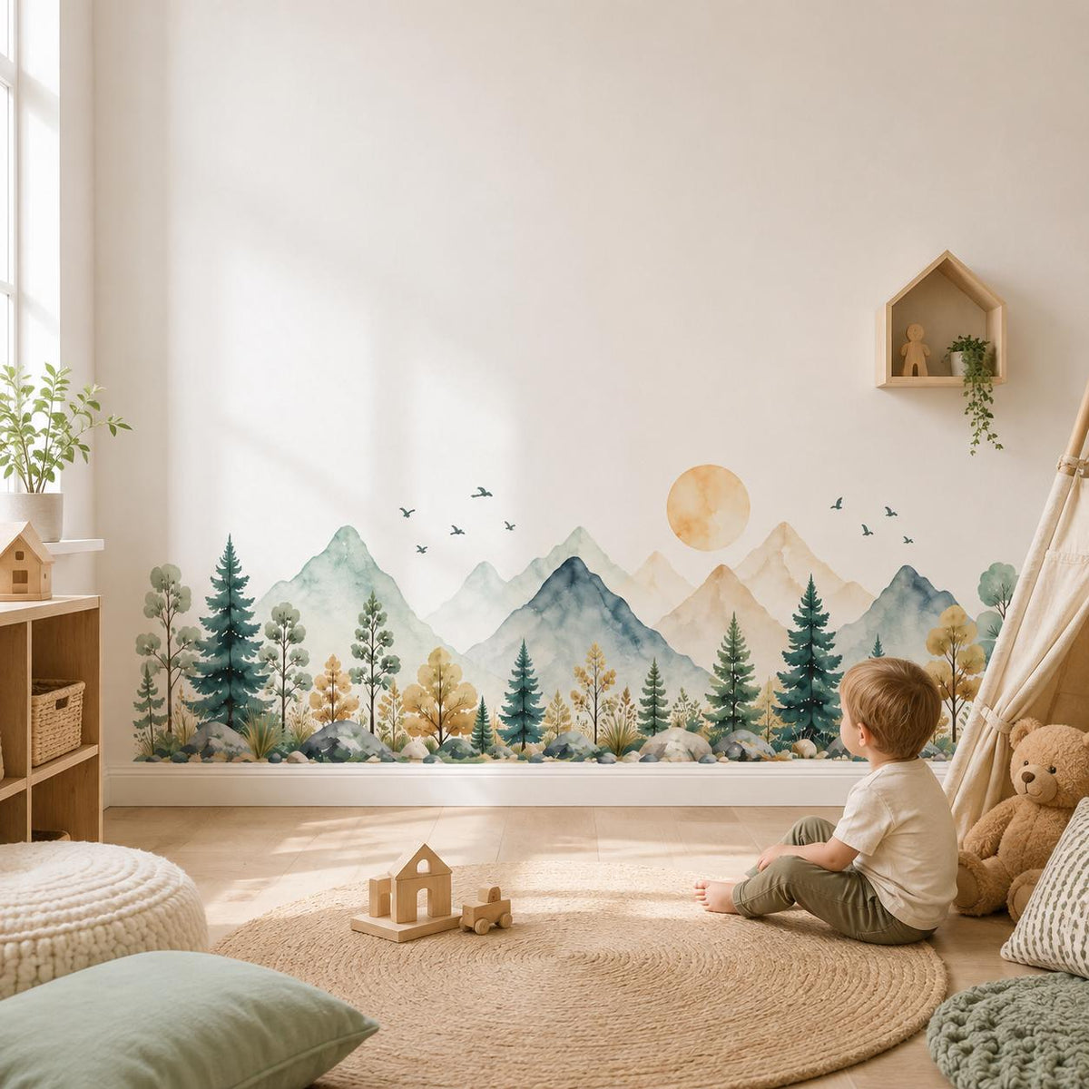 Child sitting on a woven rug below a mountain forest and golden sun wall decal in a playroom.