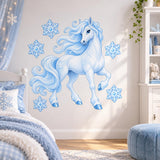 Pale blue unicorn and four snowflakes wall sticker above a child's bed beside a blue ottoman.