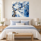 Blue flower triptych wall sticker above a pale wooden bed with blue cushions and bedside lamps.