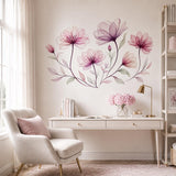 Pink and burgundy botanical wall decal above a white writing desk and cream chair in a home office.