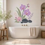 Lilac orchid flowers and black pebble wall sticker above a freestanding white bathtub in a spa bathroom.