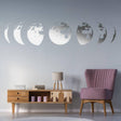 Moon phases wall decal in a modern living room decor, featuring stylish pink chair and wooden furniture.