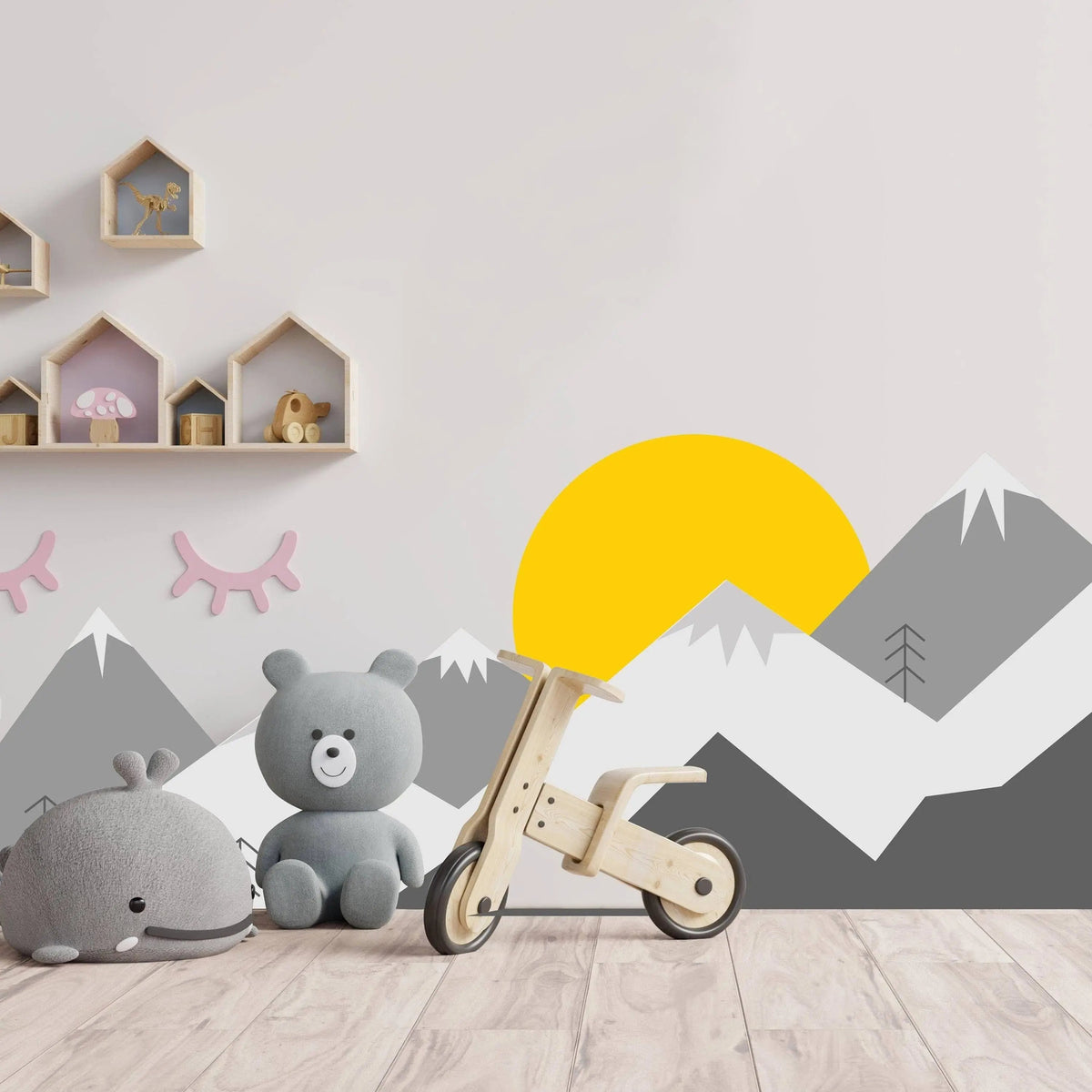 Colorful mountain wall decal in a child's room with toys and decor, featuring a vibrant sun and playful design.