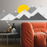 Majestic mountain wall decal with vibrant sun, enhancing cozy modern living room decor.