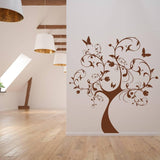 Nature's Delight decorative tree wall sticker in a bright room, featuring brown design with butterflies and floral elements.