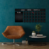 Large adhesive chalkboard wall decal displaying a monthly calendar in a stylish home setting.