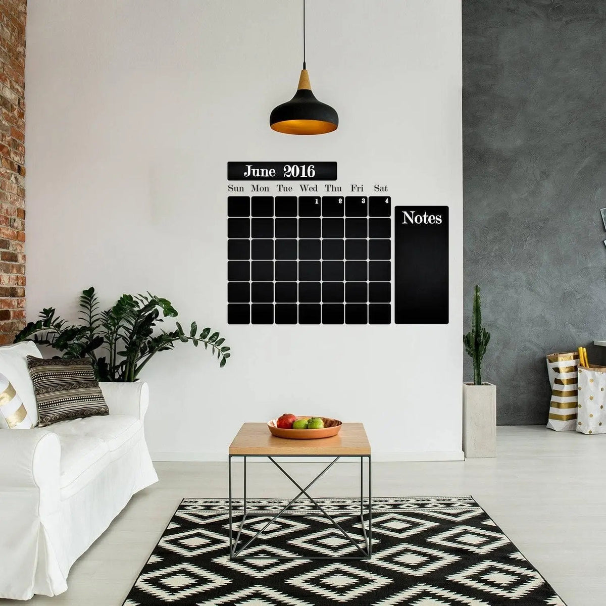 Chalkboard wall sticker with monthly planner design in a stylish living room setting.