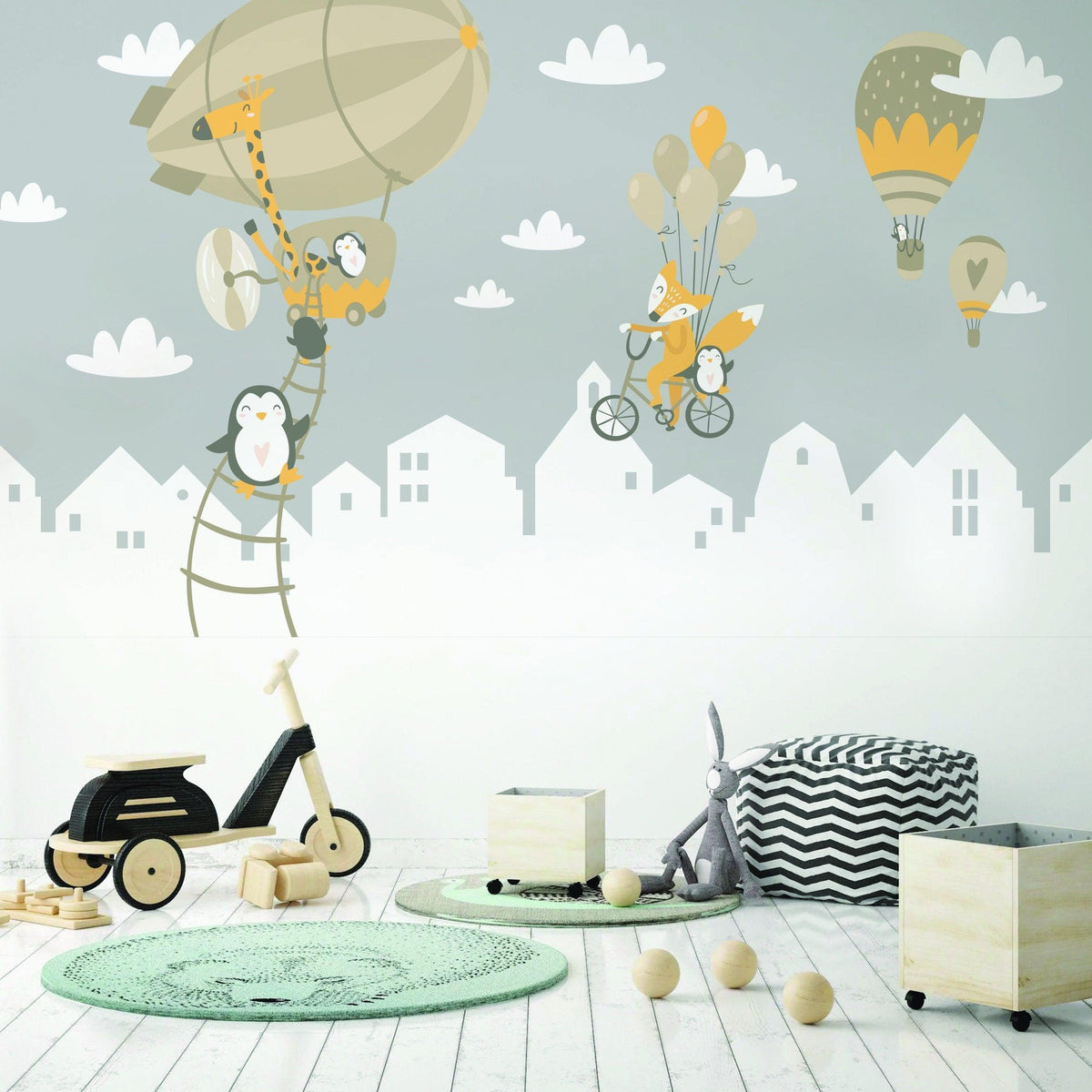 Charming animal wall stickers featuring penguins and foxes with hot air balloons in a child's room.