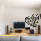 Heart-shaped picture frame decal on a wall above a modern living room TV setup with cozy furniture.