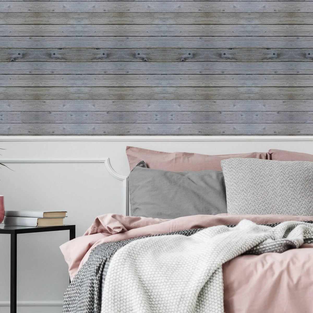 Rustic self-stick wooden plank wall decal as peel and stick wallpaper in a cozy bedroom setting.