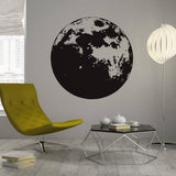 Stylish Moon Phase vinyl wall sticker applied in modern living room with yellow chair and geometric table decor.