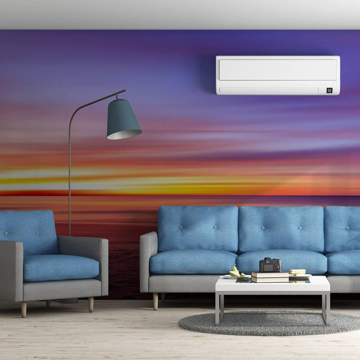 Serene sunset wall mural transforming a modern living room with blue sofas and soft lighting.