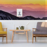Transformative sunset wall decals showcasing vibrant mountain landscape in stylish living room decor.