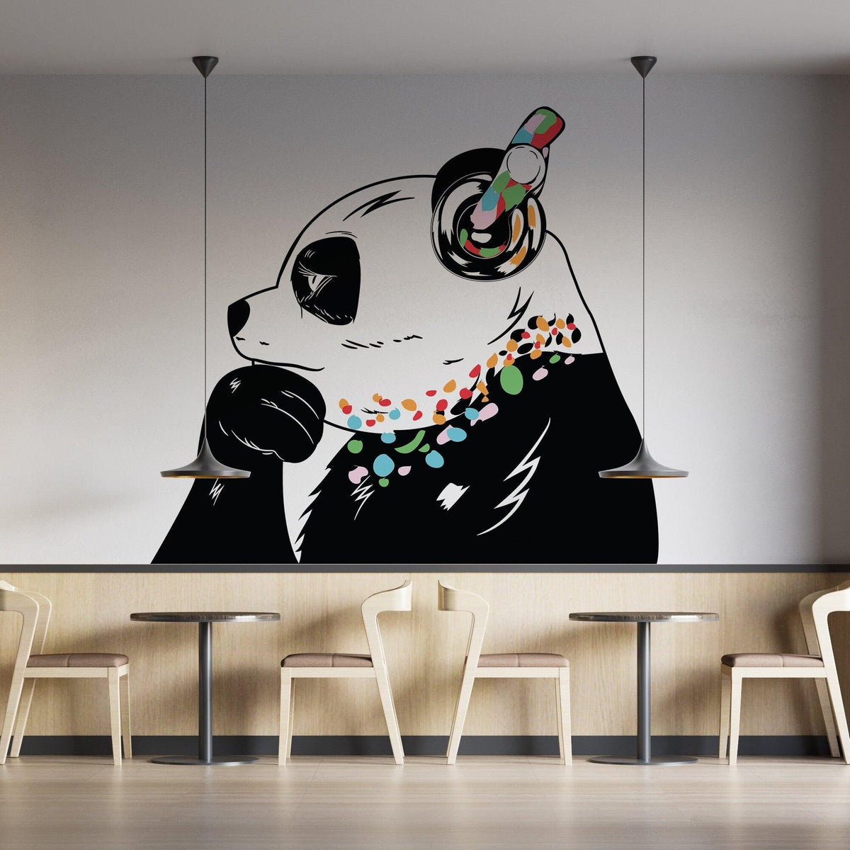 Panda in headphones street art decal with colorful accents in a cafe setting.