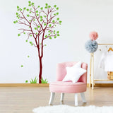 Nature's Serenity vinyl wall decal of a tree with green leaves, enhancing a stylish room decor.