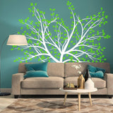 Nature's Serenity vinyl wall decal featuring a tree design with green leaves on a teal wall above a modern sofa.