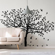 Nature-inspired tree wall decal sticker for home decoration, featuring leaves and birds in black silhouette.