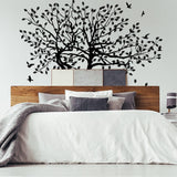 Nature-inspired tree wall decal above a cozy bed, adding a serene touch to home decor.