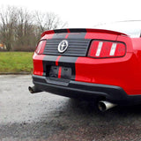 Red car with stylish black racing stripes on the back, showcasing a sporty and upgraded look.