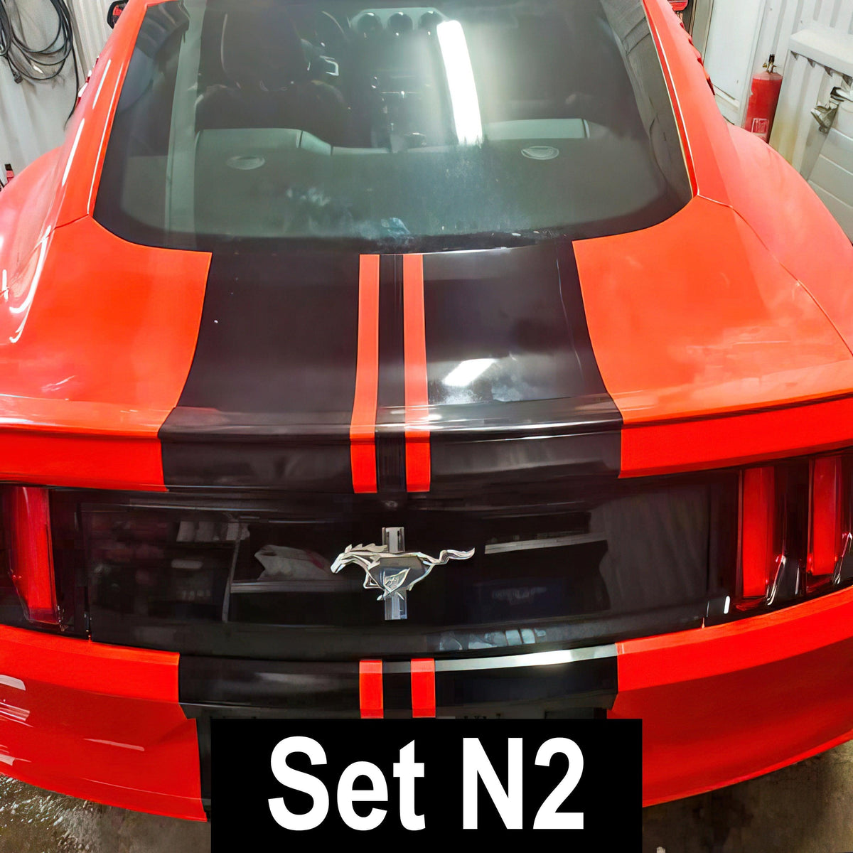 Stylish red car with black racing stripes decals, showcasing Set N2 for a sporty vehicle upgrade.