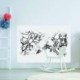 Creative dry erase vinyl decal with whimsical black drawings on a white wall.