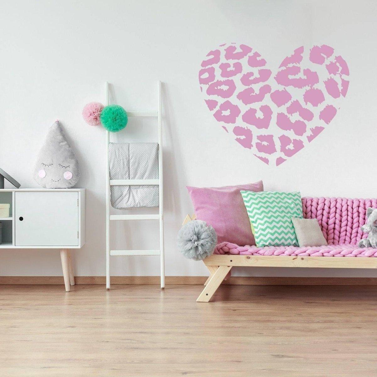 Pink leopard heart vinyl wall art decal in a stylish room with pastel decor and cozy furniture.
