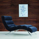 Stylish navy chair against rustic wood wall with framed blue tree artwork.