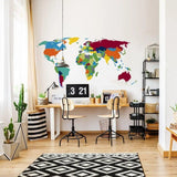 Vibrant world map wall decal in an office space, featuring colorful continents and stylish decor elements.