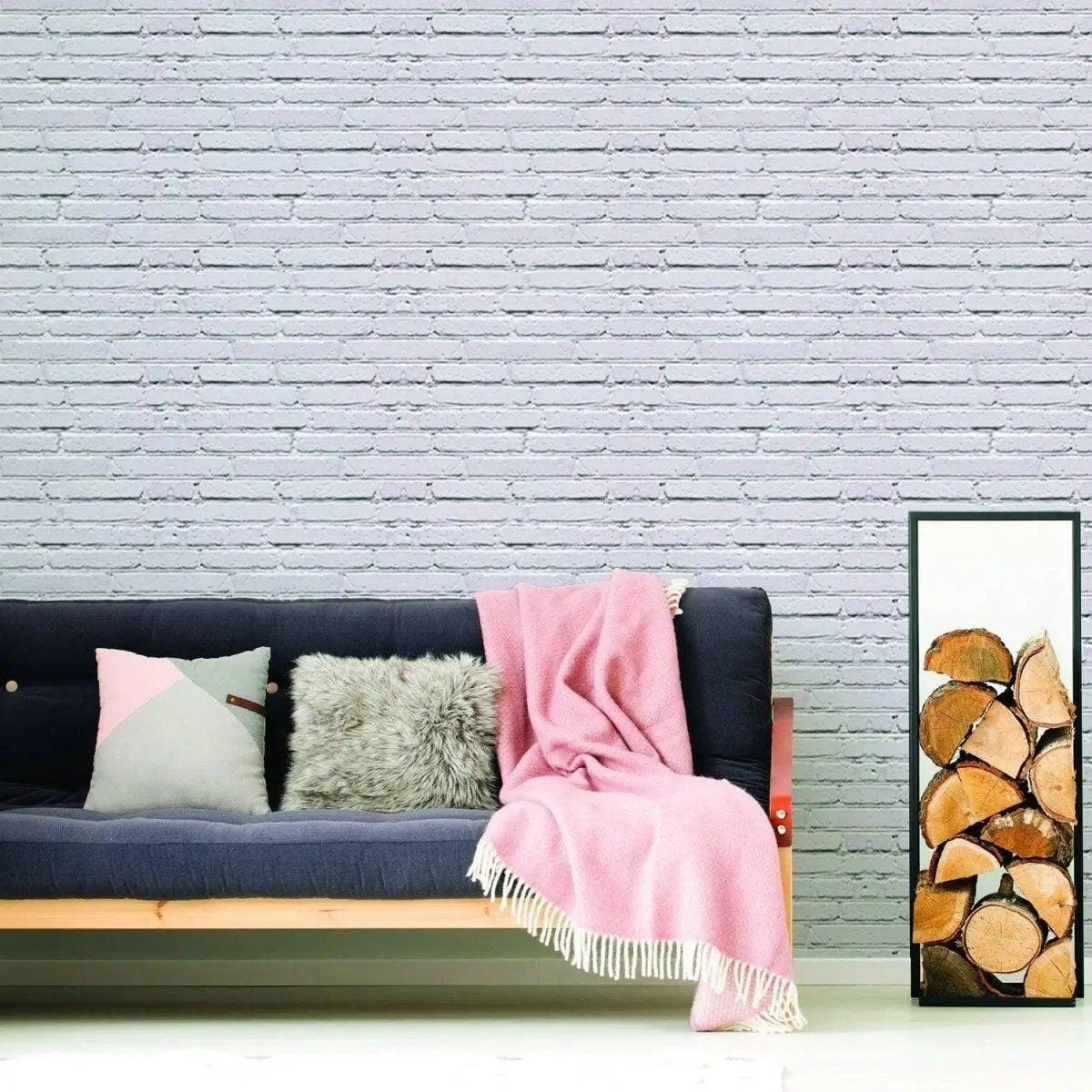 Living room featuring 3D stone wall peel and stick wallpaper with cozy sofa and decorative throw.