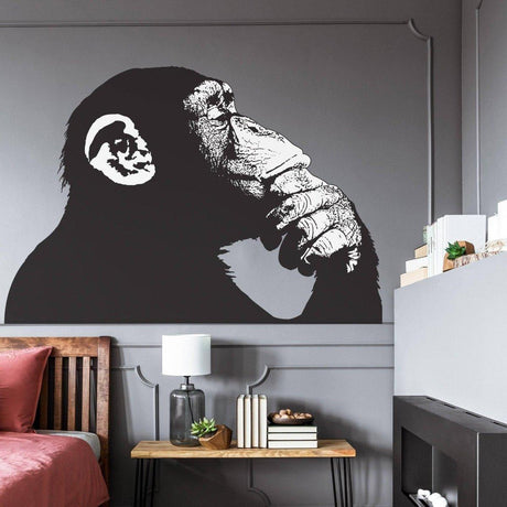 Contemporary primate wall decal of a thoughtful monkey on a stylish living room wall.