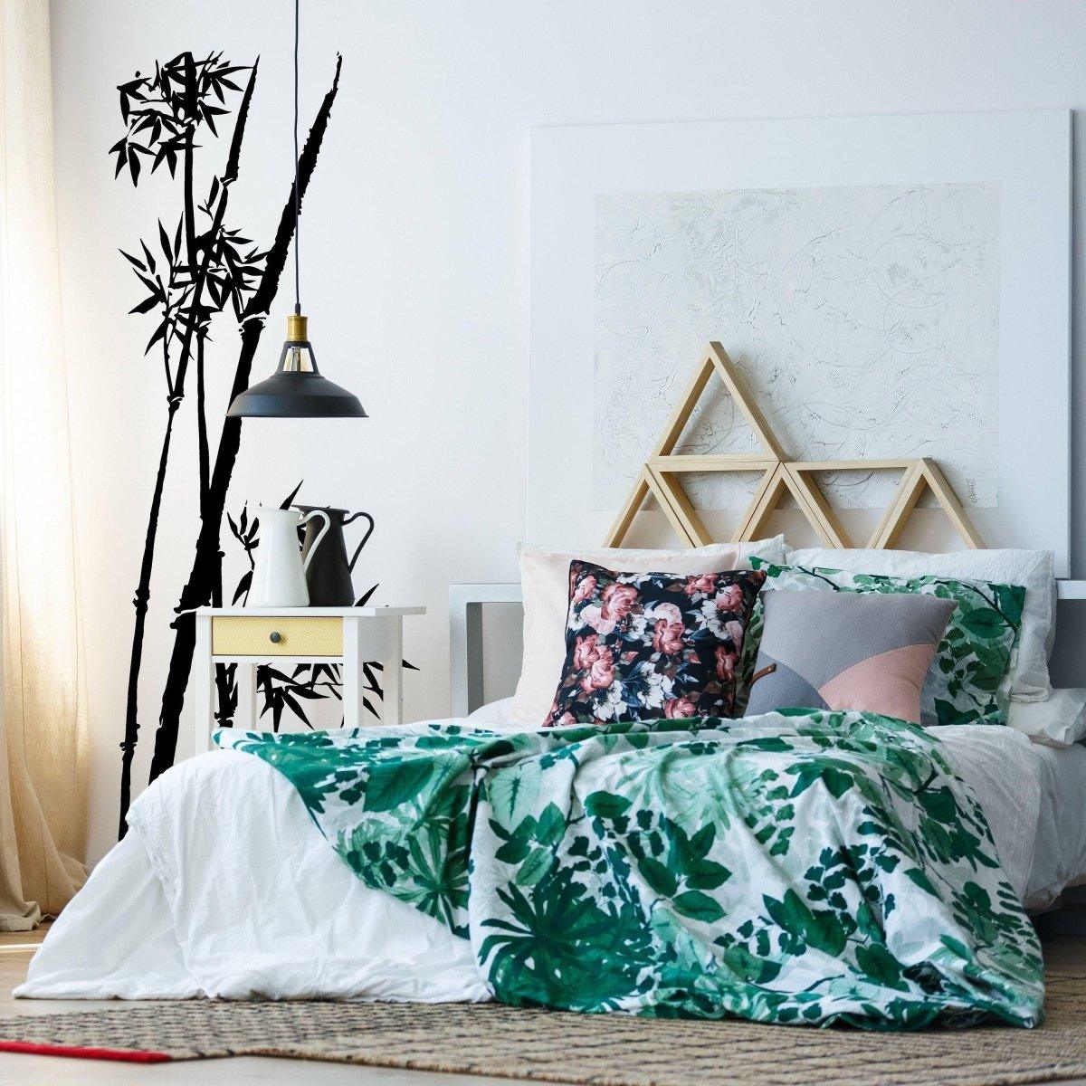 Stylish bedroom featuring a bamboo wall decal, tropical bedding, and modern decor for a serene atmosphere.