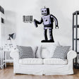 Barcode robot wall sticker displayed above a cozy sofa in a modern interior.
