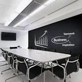 Modern conference room with a chalkboard wall sticker featuring business concepts and teamwork.