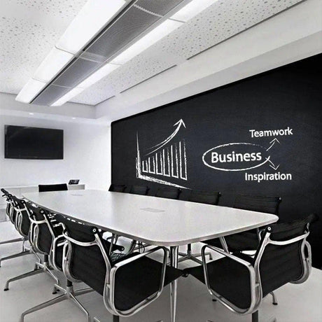 Modern conference room with a chalkboard wall sticker featuring business concepts and teamwork.