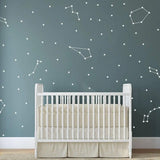 Celestial Dreams themed vinyl wall stickers displaying constellations above a crib in a nursery.