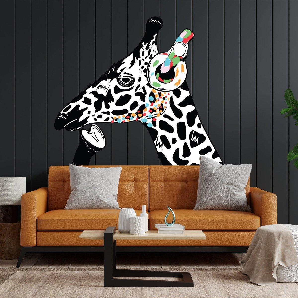 Contemplative giraffe wall sticker with headphones on a black wall above an orange sofa.