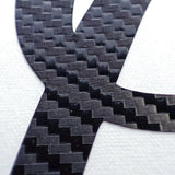 Close-up of personalized carbon fiber letter sticker showcasing a sleek.