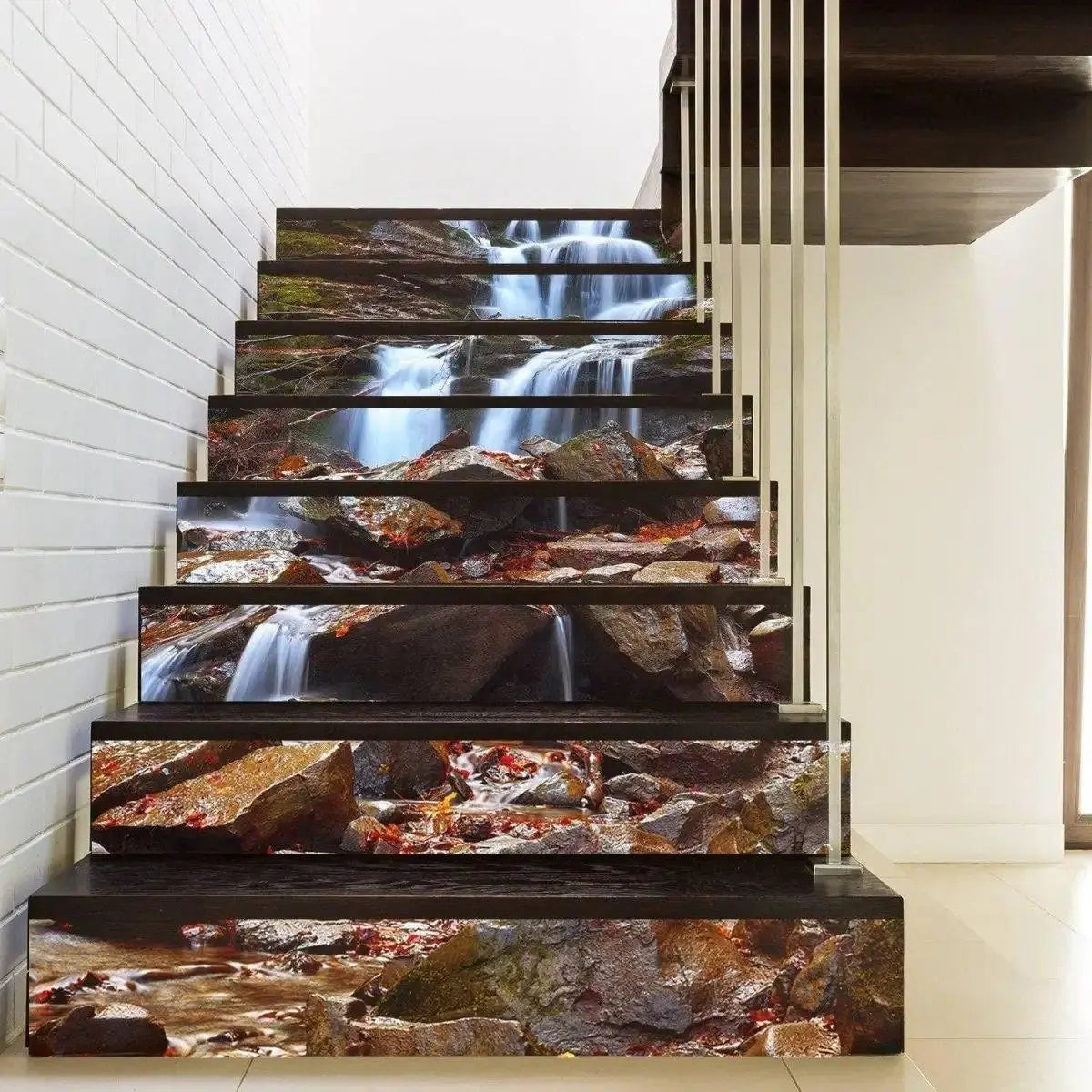 Rocky waterfall stair riser decals on a modern staircase, forming a continuous stream and stone mural across the steps.