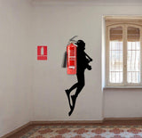 Scuba diver wall sticker with a fire extinguisher displayed in an interior.