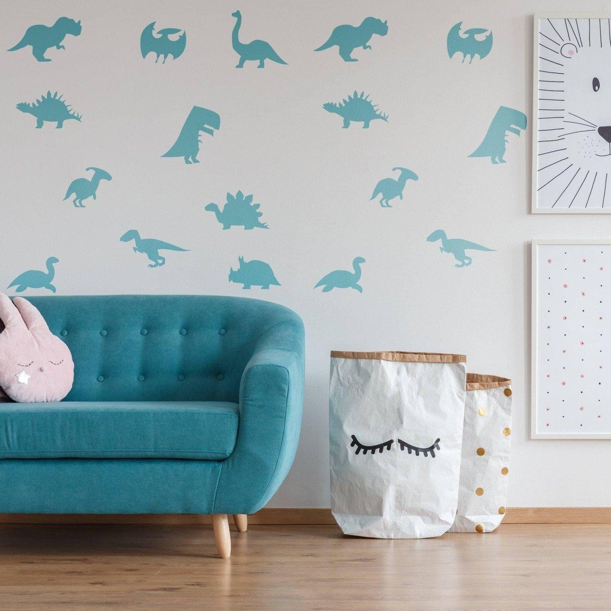 Dinosaur Dreams Wall Sticker Set featuring turquoise dinosaur silhouettes on a decorated wall above a cozy teal couch.
