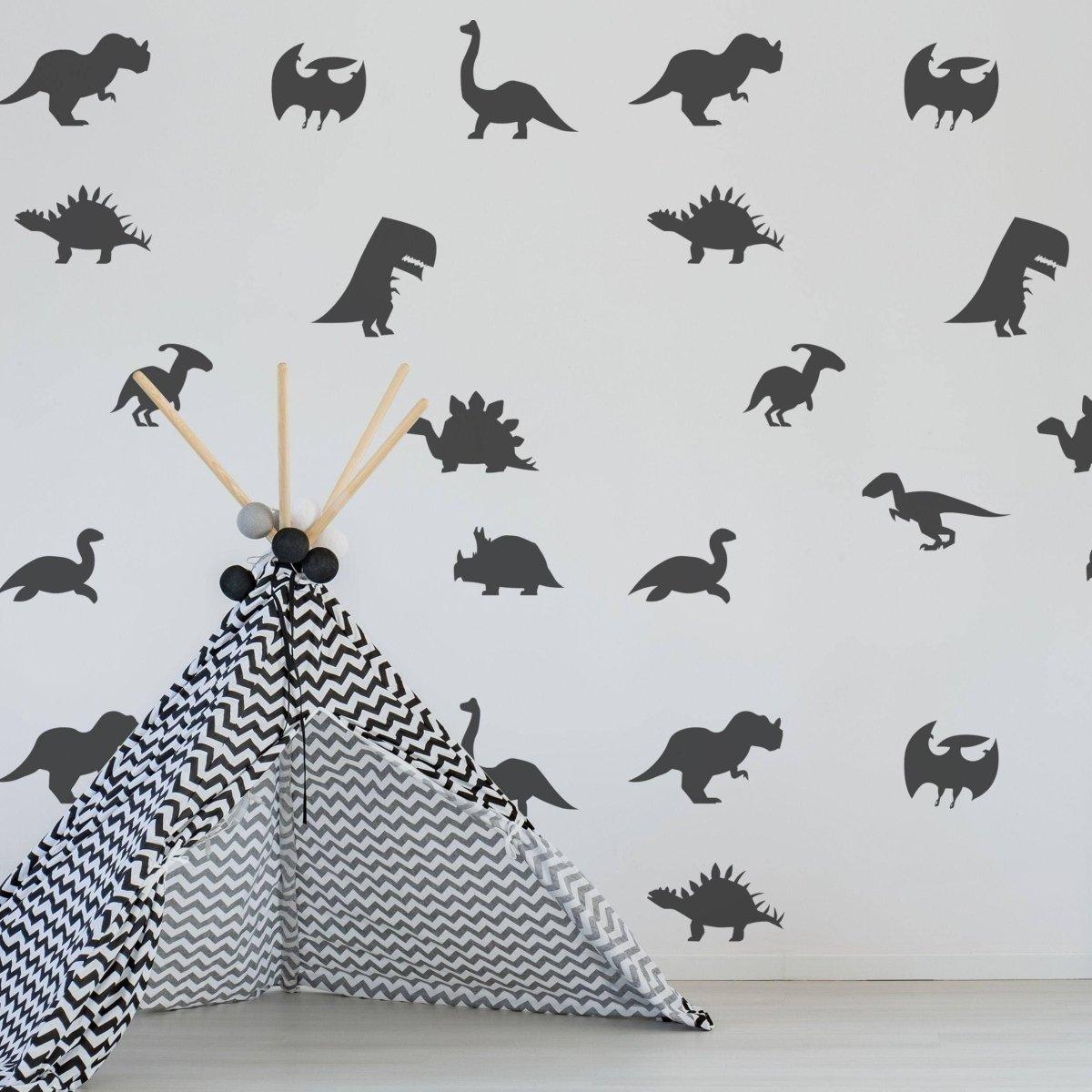 Dinosaur Dreams wall sticker set showcasing black dinosaur silhouettes on a white wall, with a patterned teepee in view.