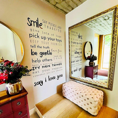 Inspirational wall decal with positive quotes in a cozy home setting, featuring a mirror and floral decor.
