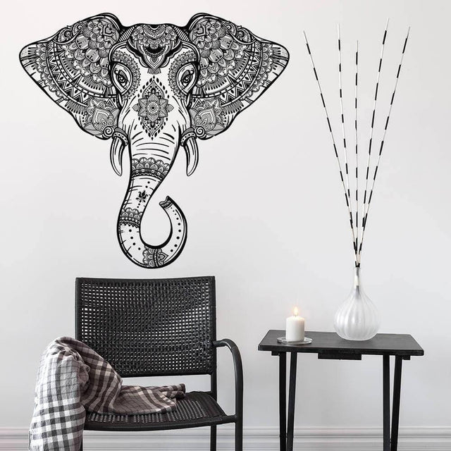 Whimsical elephant wall art decal in stylish design above a modern chair and table, adding charm to any decor.