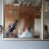 Frosted window film decal providing privacy while allowing natural light to shine through.