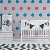 Chic nursery decor with colorful circle wall stickers and a crib, featuring decorative bunting and modern design.