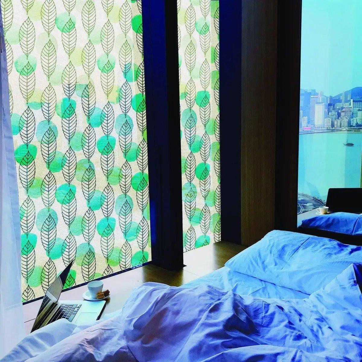 Leaf-patterned privacy glass film on windows, enhancing privacy and style in a cozy bedroom.